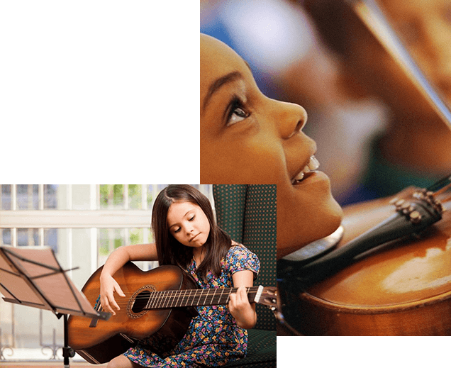 A young girl playing the guitar and smiling.