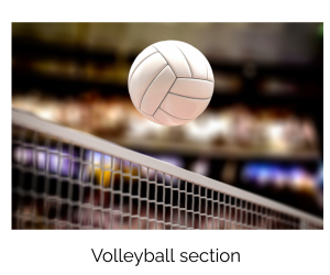 A volleyball is flying through the air over a net.