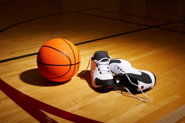 A basketball and some shoes on the floor