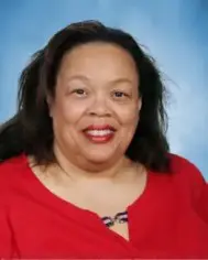 A woman in red shirt smiling for the camera.