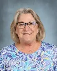 A woman with glasses and a blue shirt