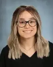 A woman with glasses and long hair.